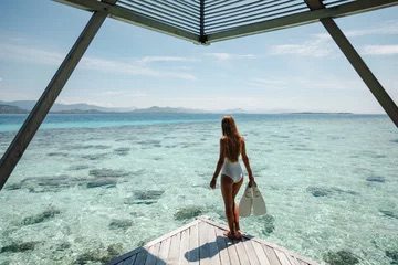 Woman on Wooden Pier With Snorkeling Equipment.